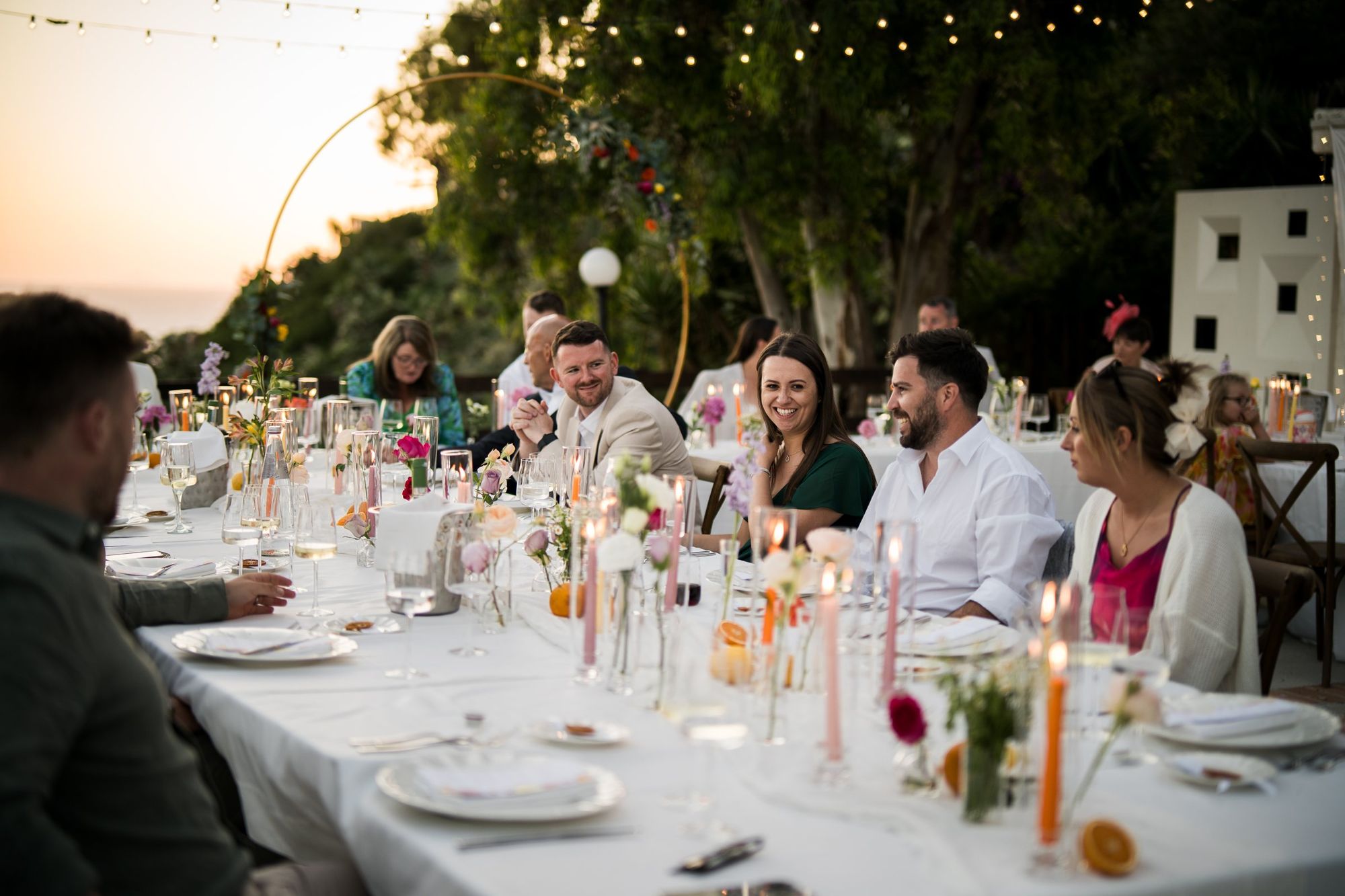 Long dinner table with candles at dusk